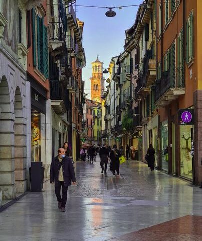 Charming street in Verona featuring Torre dei Lamberti.