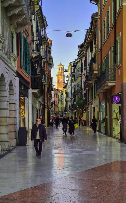 Charming street in Verona featuring Torre dei Lamberti.
